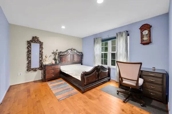 Bedroom with dark wood furniture and desk
